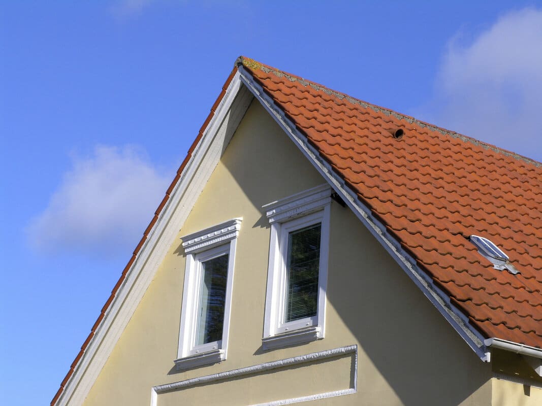 House gable with a dormer and asphalt shingle roof